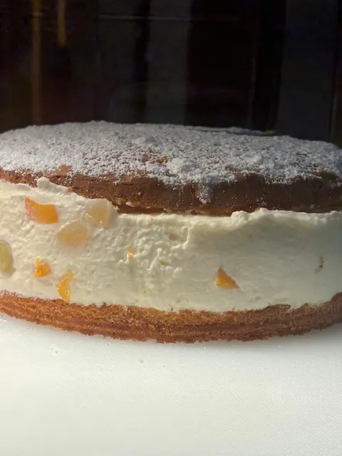 Whole cream cake of the day dusted with icing sugar.