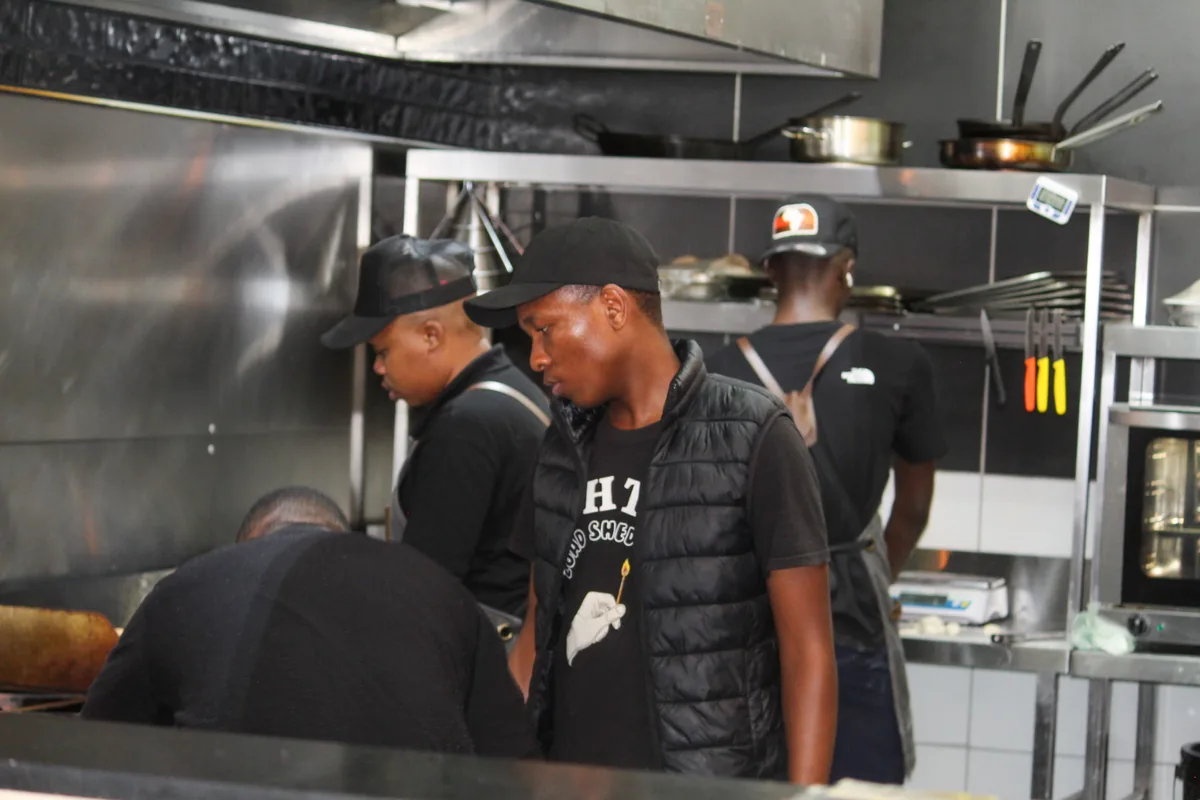 The Salt & Roost kitchen team working together at the grill.