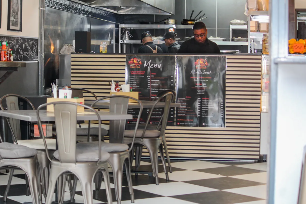 Salt & Roost's open kitchen and service counter behind the chequerboard dining floor.