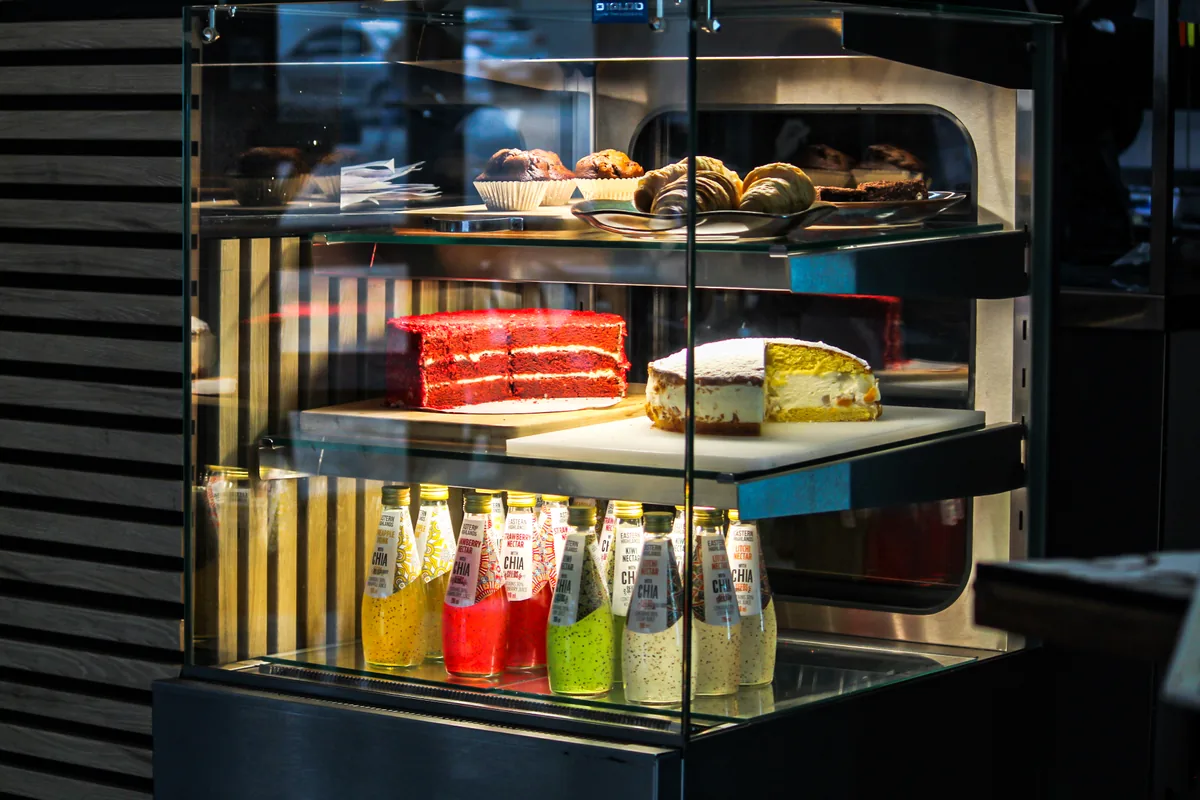 Pastries, cakes and bottled juices displayed at the Salt & Roost counter.